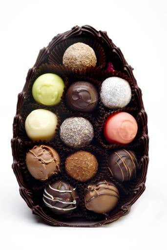 Half a milk chocolate egg filled with chocolate truffles